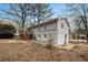 Rear exterior featuring a raised deck, concrete patio, and gray siding at 5257 Orly Ter, Atlanta, GA 30349