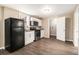 Compact kitchen boasts stainless steel appliances, white cabinets, and wood-look flooring at 5257 Orly Ter, Atlanta, GA 30349