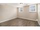 Spacious room featuring wood-look floors, and natural light from two windows at 5257 Orly Ter, Atlanta, GA 30349