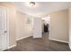 Open room with wood-look floors, connecting to a kitchen area, and has good light at 5257 Orly Ter, Atlanta, GA 30349