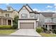 A two-story home with an attached garage, manicured lawn, and a driveway at 2625 Draw Dr, Marietta, GA 30066