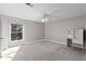 Spacious bedroom with soft carpet, a ceiling fan, a large window, and a built-in desk at 765 Houston Mill Ne Rd # 7, Atlanta, GA 30329