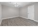 Clean bedroom with neutral walls, wood-look flooring, white trim, and a modern chandelier at 765 Houston Mill Ne Rd # 7, Atlanta, GA 30329
