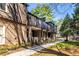 Exterior view of the brick building with covered porch, landscaping and mature trees at 765 Houston Mill Ne Rd # 7, Atlanta, GA 30329