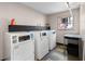 Bright laundry room featuring multiple washing machines, countertop space, and window at 765 Houston Mill Ne Rd # 7, Atlanta, GA 30329