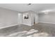 Spacious living room featuring modern gray flooring, fresh paint, and easy access to kitchen and hall at 765 Houston Mill Ne Rd # 7, Atlanta, GA 30329