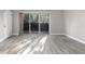 Bright, open living room with wood-look flooring and a large sliding glass door to the balcony at 765 Houston Mill Ne Rd # 7, Atlanta, GA 30329