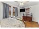 Bright bedroom features hardwood floors, two large windows, and a modern ceiling fan at 1111 Briarcliff Ne Pl # 2, Atlanta, GA 30306