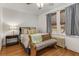 Comfortable bedroom featuring neutral tones, two windows, and a decorative bench at 1111 Briarcliff Ne Pl # 2, Atlanta, GA 30306
