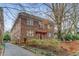 Charming brick building with a red awning, an American flag, and lush landscaping, creating a welcoming curb appeal at 1111 Briarcliff Ne Pl # 2, Atlanta, GA 30306