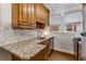 Bright kitchen featuring wood cabinets, granite countertops, and white tile backsplash at 1111 Briarcliff Ne Pl # 2, Atlanta, GA 30306