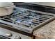 Close up of a stainless steel gas range with granite countertops at 1111 Briarcliff Ne Pl # 2, Atlanta, GA 30306