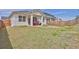 Large backyard with a covered patio, wood fencing, and a fire pit at 1991 Vidalia Ct, Dacula, GA 30019