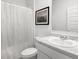 Bathroom featuring a toilet, shower with curtain, and marble counter top sink at 1991 Vidalia Ct, Dacula, GA 30019