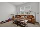 Bedroom area with a cozy couch, wooden table, and bright natural light at 1991 Vidalia Ct, Dacula, GA 30019