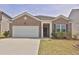 Charming brick home with a well-maintained lawn, a two-car garage, and meticulous landscaping at 1991 Vidalia Ct, Dacula, GA 30019