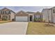 Inviting brick home featuring manicured landscaping, a two-car garage, and a welcoming entrance at 1991 Vidalia Ct, Dacula, GA 30019