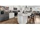 Modern kitchen boasts stainless steel appliances, granite counters, an island, and ample cabinet space at 1991 Vidalia Ct, Dacula, GA 30019