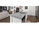 Bright kitchen island features a gray and white granite countertop with a stainless steel sink and a dishwasher at 1991 Vidalia Ct, Dacula, GA 30019