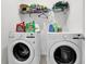 Laundry room area featuring a white washer and dryer, with storage above at 1991 Vidalia Ct, Dacula, GA 30019