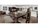 Open concept room featuring hardwood flooring, modern ceiling fan, gallery wall and modern kitchen area at 1991 Vidalia Ct, Dacula, GA 30019