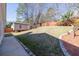 Spacious backyard with a shed, mature trees, and a fenced perimeter at 395 Shadetree Ln, Lawrenceville, GA 30044
