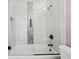 Detailed view of the tub-shower combination with marble tile and a rainfall shower head at 395 Shadetree Ln, Lawrenceville, GA 30044