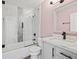 Well-lit bathroom with marble countertops, shower-tub combination, and modern fixtures at 395 Shadetree Ln, Lawrenceville, GA 30044