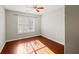 Neutral bedroom showcasing hardwood floors, a window for natural light, and ample space at 395 Shadetree Ln, Lawrenceville, GA 30044