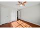 Bright bedroom featuring hardwood floors, a ceiling fan, and ample closet space at 395 Shadetree Ln, Lawrenceville, GA 30044
