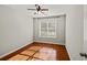 Cozy bedroom with hardwood floors, a ceiling fan, and a window view at 395 Shadetree Ln, Lawrenceville, GA 30044