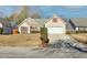 Charming one story home features a 2-car garage, neutral siding and lovely stone accents at 395 Shadetree Ln, Lawrenceville, GA 30044
