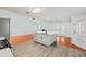 Bright, open kitchen features an island with seating, laminate floors and stainless appliances at 395 Shadetree Ln, Lawrenceville, GA 30044