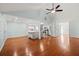 Open concept living area features hardwood floors and seamlessly connects to the kitchen at 395 Shadetree Ln, Lawrenceville, GA 30044