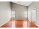 Primary bedroom features high ceiling, fan, and wood flooring at 395 Shadetree Ln, Lawrenceville, GA 30044