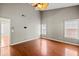 Primary bedroom features high ceiling, fan, and wood flooring at 395 Shadetree Ln, Lawrenceville, GA 30044