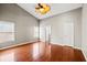 Primary bedroom features high ceiling, fan, and wood flooring at 395 Shadetree Ln, Lawrenceville, GA 30044
