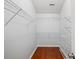Walk-in closet with hardwood floors and shelving at 395 Shadetree Ln, Lawrenceville, GA 30044