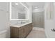 Elegant bathroom with a double vanity, large mirror, and glass-enclosed shower at 775 Juniper Ne St # 111, Atlanta, GA 30308