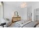 Cozy bedroom featuring a comfortable chair, wood dresser, and contemporary light fixture at 775 Juniper Ne St # 111, Atlanta, GA 30308