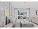Chic bedroom with decorative wall panels, large windows, and modern furnishings at 775 Juniper Ne St # 111, Atlanta, GA 30308