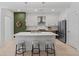 Sleek kitchen with a large island and seating, stainless steel appliances, and a modern design aesthetic at 775 Juniper Ne St # 111, Atlanta, GA 30308