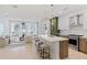 Open living space with modern kitchen, island seating, and light hardwood floors for a bright and airy feel at 775 Juniper Ne St # 111, Atlanta, GA 30308
