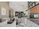 A modern open-concept lounge with a kitchen area, fireplace, and floor-to-ceiling glass doors at 775 Juniper Ne St # 111, Atlanta, GA 30308