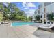 Community pool featuring lounge chairs and exterior of building at 775 Juniper Ne St # 111, Atlanta, GA 30308