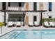 Relaxing poolside view with comfortable lounge chairs and a pergola providing shade for ultimate comfort at 775 Juniper Ne St # 111, Atlanta, GA 30308