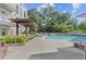 Community pool featuring lounge chairs, landscaping, and shade canopy at 775 Juniper Ne St # 111, Atlanta, GA 30308