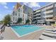 Community pool surrounded by lounge chairs in complex at 775 Juniper Ne St # 111, Atlanta, GA 30308