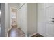 Hallway with wood floors and a view of a half bathroom at 1099 Wynford Cmns, Marietta, GA 30064