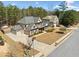 Aerial view of a house with a large driveway and mature landscaping, highlighting curb appeal at 1439 Mill Pointe Ct, Lawrenceville, GA 30043